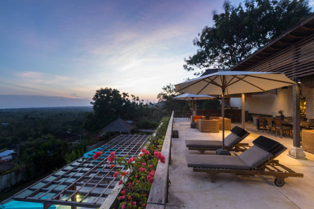 istock Illuminated terrace in a luxurious villa with armchairs at sunrise 962000110