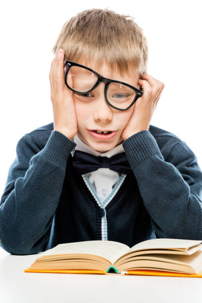 istock upset schoolboy with a book on a white background 962005770