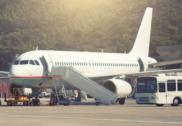 istock White airplane in airport serviced by the ground crew 962009808