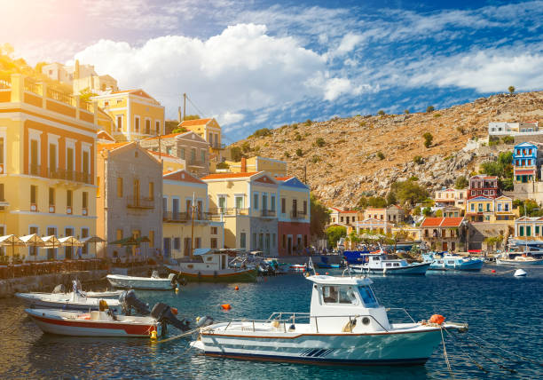 Greece, traditional view of Greek coastline - small fishing boats anchored at the wooden quay. Greece, traditional view of Greek coastline - small fishing boats anchored at the wooden quay. ithaca stock pictures, royalty-free photos & images