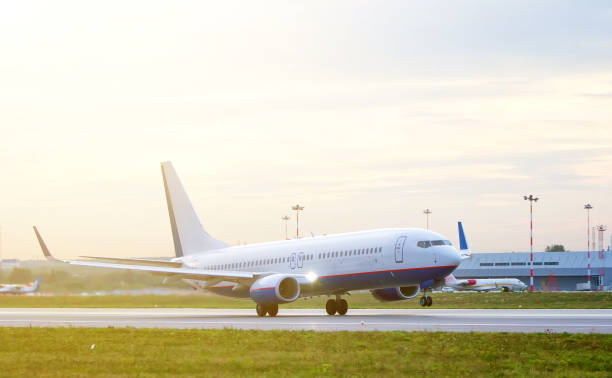 istock passenger plane fly up over take-off runway from airport at sunset 962014682
