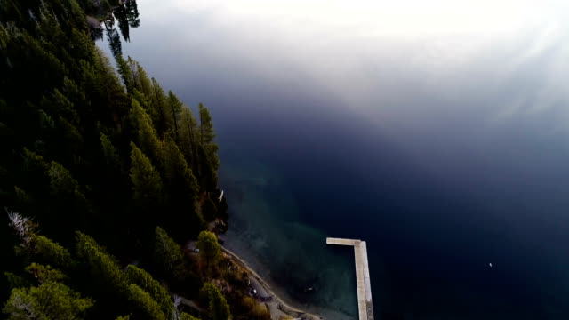 Straight down drone view above Lake Tahoe , California panning up to Sunrise over Emerald Bay