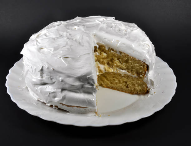 White two layer cake on black background stock photo