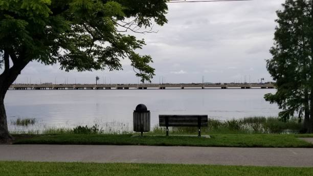 istock Park bench trashcan lake and bridge trail 962031270