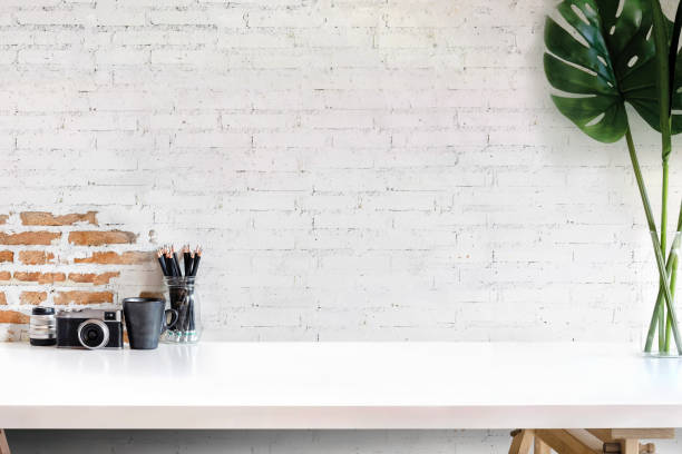 istock Loft workspace with photographer equipment on white wood table at home or studio. 962036144