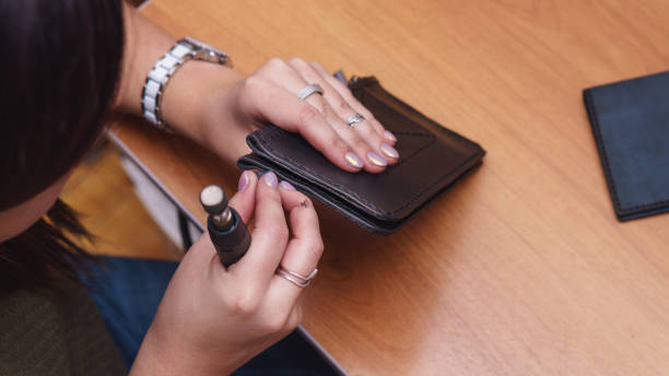 istock Tanner polishes edges of leather 962037006