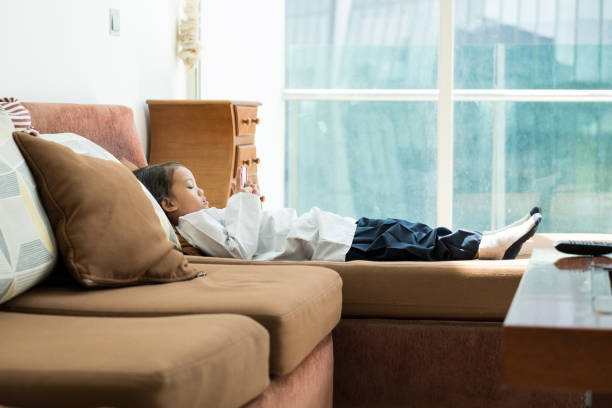 istock Young girl playing on a mobile phone 962037174