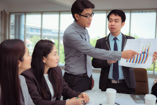 istock Businessman pointing on data sheet during presentation in office, Business and people concept 962037404