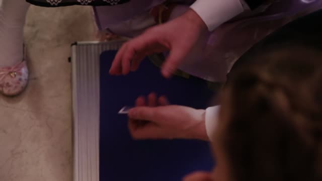 Magician shows tricks with cards