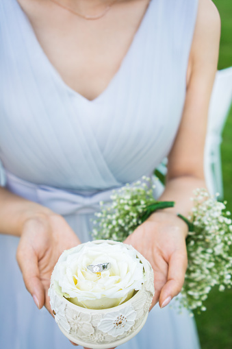 Bridesmaid holding wedding ring