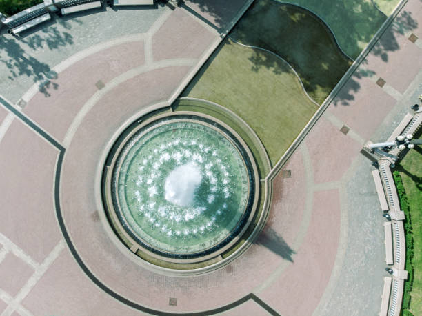 aerial drone photo of fountain in city park aerial drone bird's eye view photo of fountain in city park stone bench top view stock pictures, royalty-free photos & images