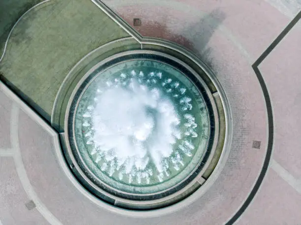 aerial view of large round fountain in city square. drone photography