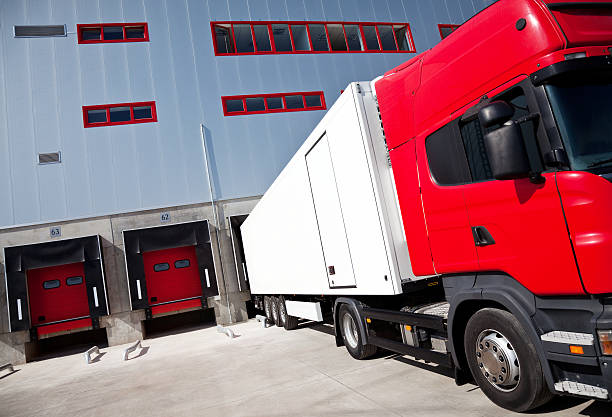 istock Red and white 18-wheel truck at a loading dock 96205054