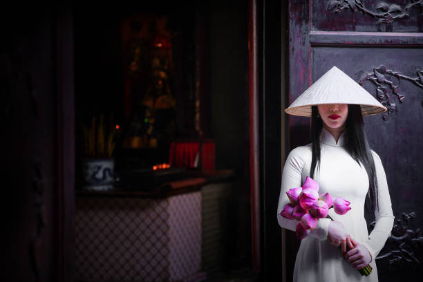 Woman wearing Ao Dai culture traditional at old temple. Vietnam woman wearing Ao Dai culture traditional at old temple at Ho Chi Minh in Vietnam,vintage style,travel and relaxing concept. ao dai stock pictures, royalty-free photos & images