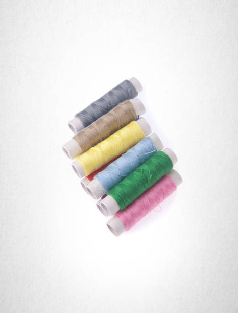 istock bobbins or bobbins of thread on a background 962054550