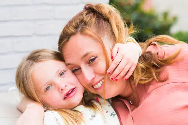 Photo of Mother and daughter smiling and laughing