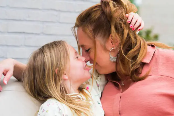 Photo of Mother and daughter smiling and laughing