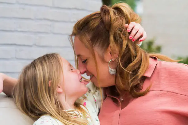 Photo of Mother and daughter smiling and laughing