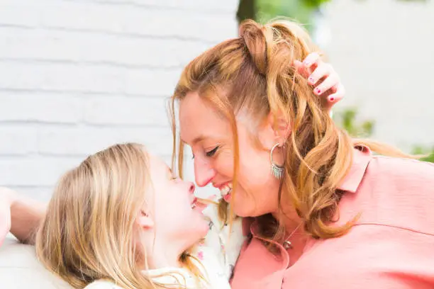 Photo of Mother and daughter smiling and laughing