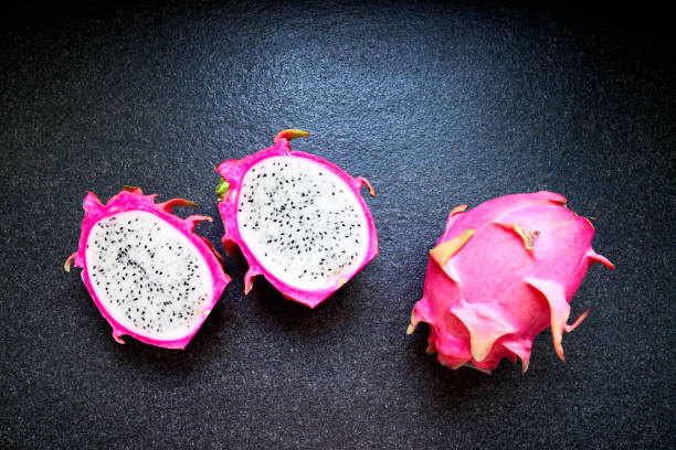 istock Fresh ripe dragon fruits isolated on granite plate background 962055888