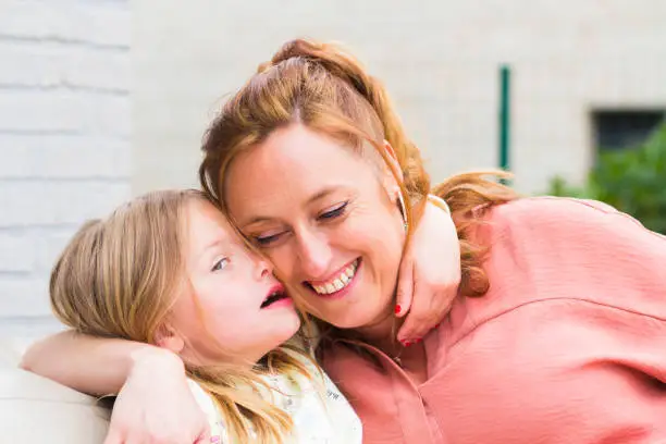 Photo of Mother and daughter smiling and laughing