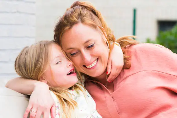 Photo of Mother and daughter smiling and laughing