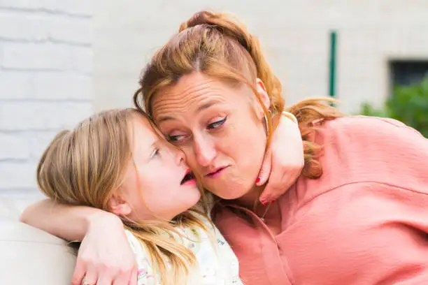 Photo of Mother and daughter smiling and laughing