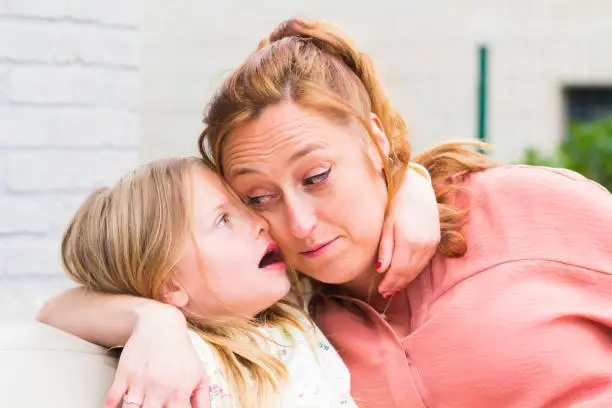 Photo of Mother and daughter smiling and laughing