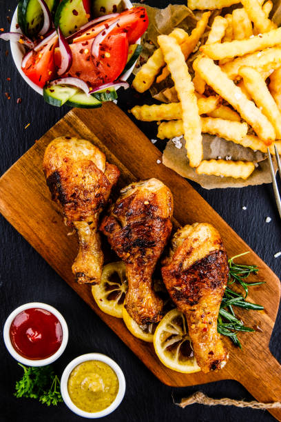 istock Fried chicken drumstics with French fries 962056978