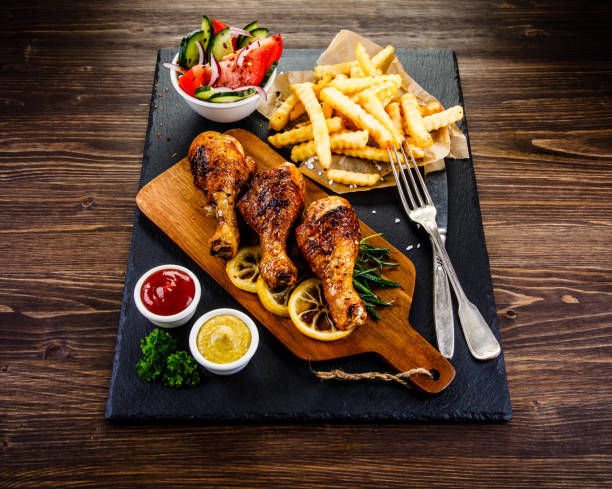 istock Fried chicken drumstics with French fries 962057000