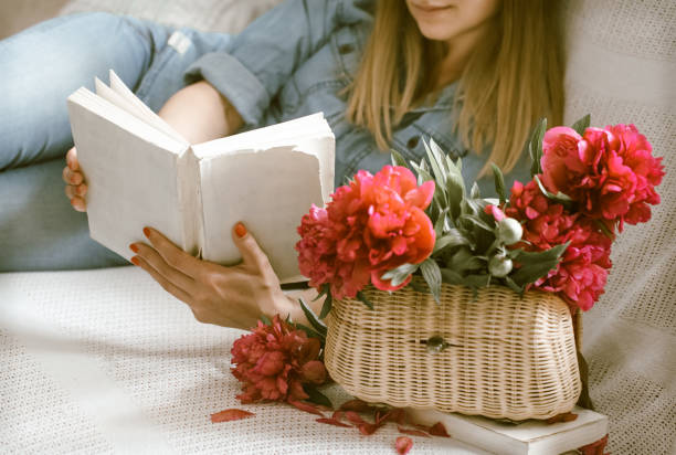 istock girl on the couch reading books 962060470