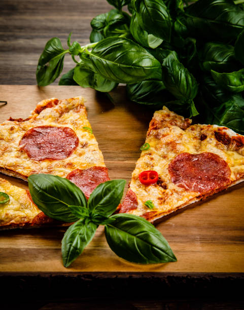 istock Pizza pepperoni on wooden background 962061012