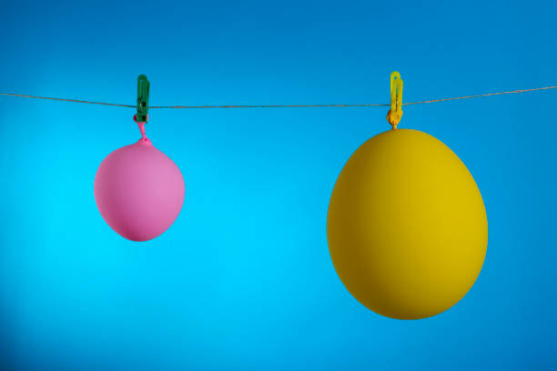 Yellow and pink balloons hang on a rope