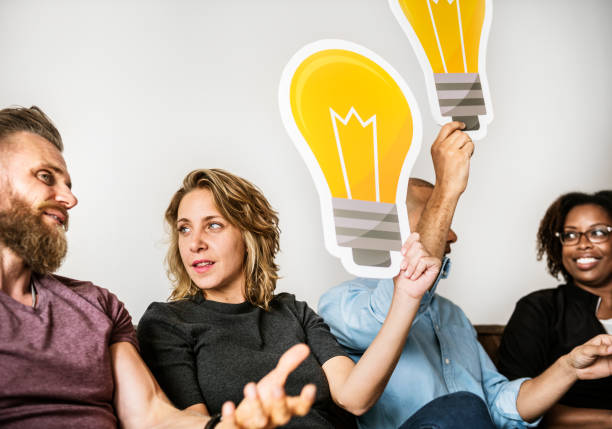 istock People carrying light bulb icons 962061508