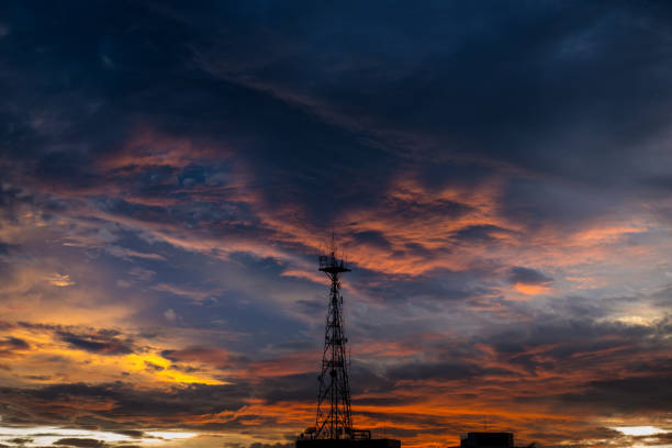 istock Silhouette of cellular tower with beautiful sunset cloudy sky 962061798