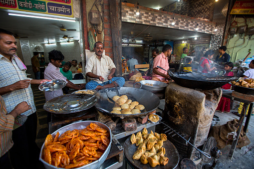 Indian street food vendors near the holy Ganges river. According to legends, Varanasi city was founded by God Shiva about 5000 years ago.