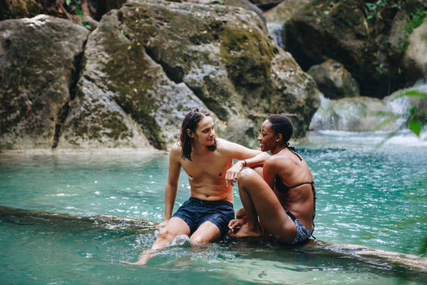 istock Friends hanging out by a waterfall in the jungle 962066296