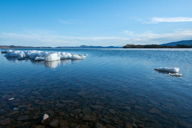 The white ice floes on the blue water of the lake. Lake Baikal in spring.