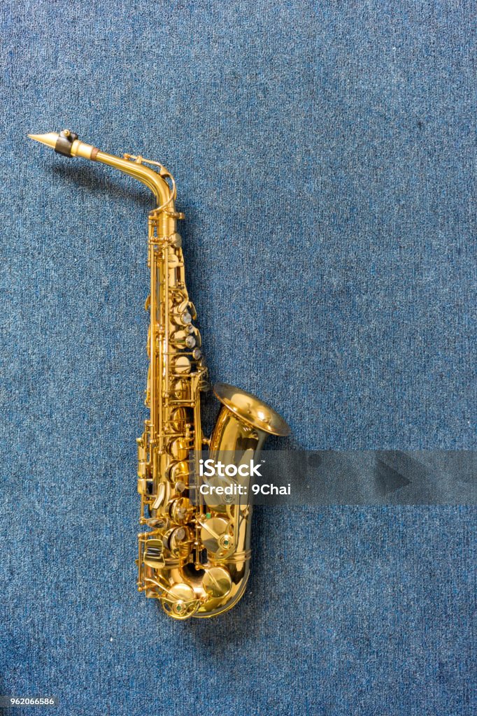 Jazz musician Golden saxophone on blue wall background Tenor Stock Photo