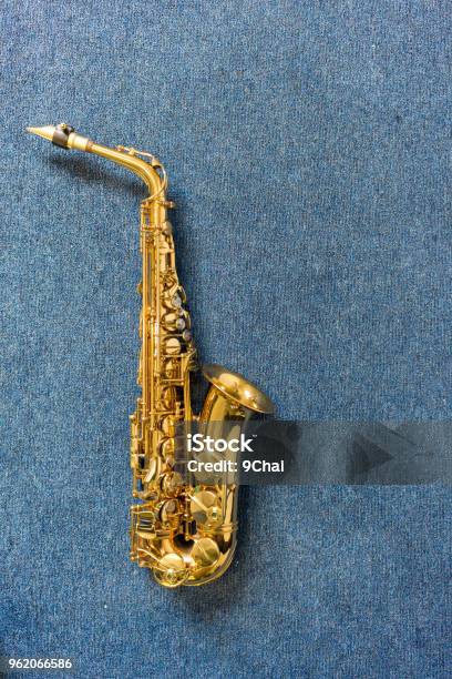 Jazz Musician Golden Saxophone On Blue Wall Background Stock Photo - Download Image Now