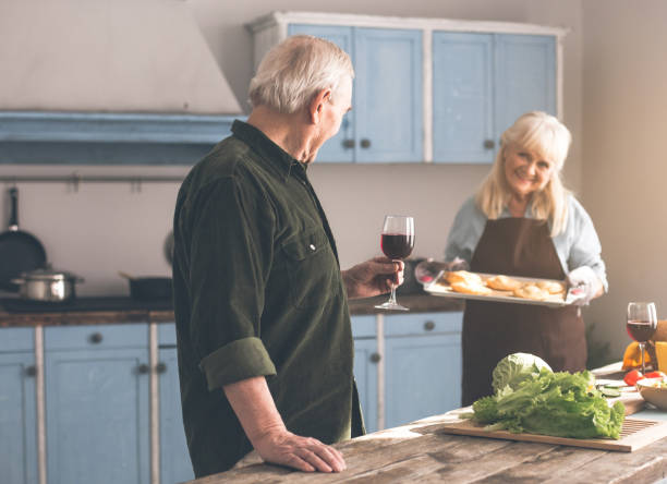istock Joyful senior woman cooking pastry for man 962067308