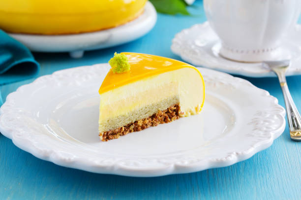 istock Cake with orange mousse and almond krokantom in the mirror glaze. Selective focus. 962070110