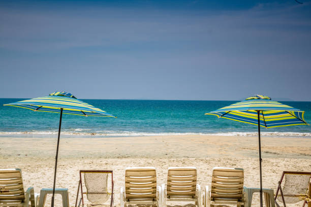 istock Morning beach chairs and umbrella 962071244