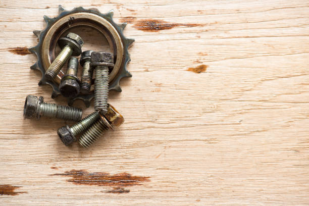 istock Dirty gear and nuts on wood board 962071322