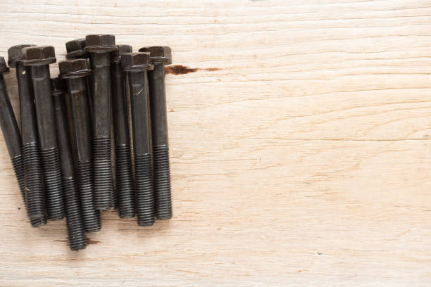 istock Dirty bolt and nuts on wood board 962071334