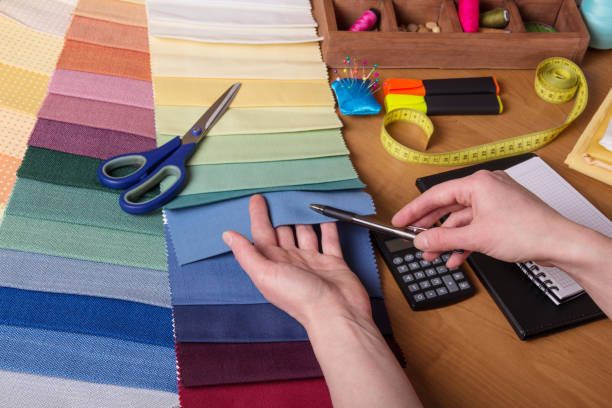 istock Choice of fabric for sewing, sewing accessories on table 962072194