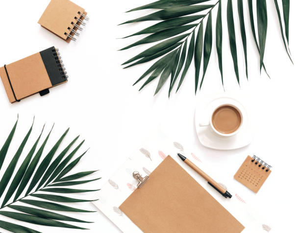 istock Flat Lay Home office workspace mockup with clipboard, tropical leaves  and coffee on white background. Blogger background 962078066