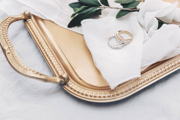 Wedding rings on gold tray. Elegant wedding background