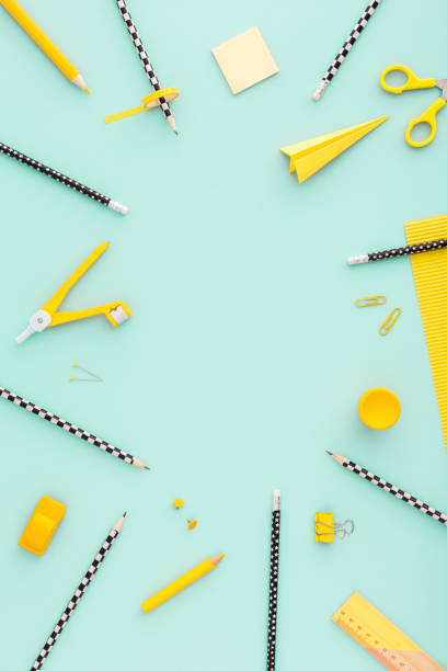 istock Green background and yellow school supplies. Flat lay. 962078546