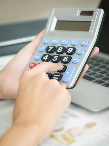 istock Woman accountant or bank worker uses calculator. 962080996